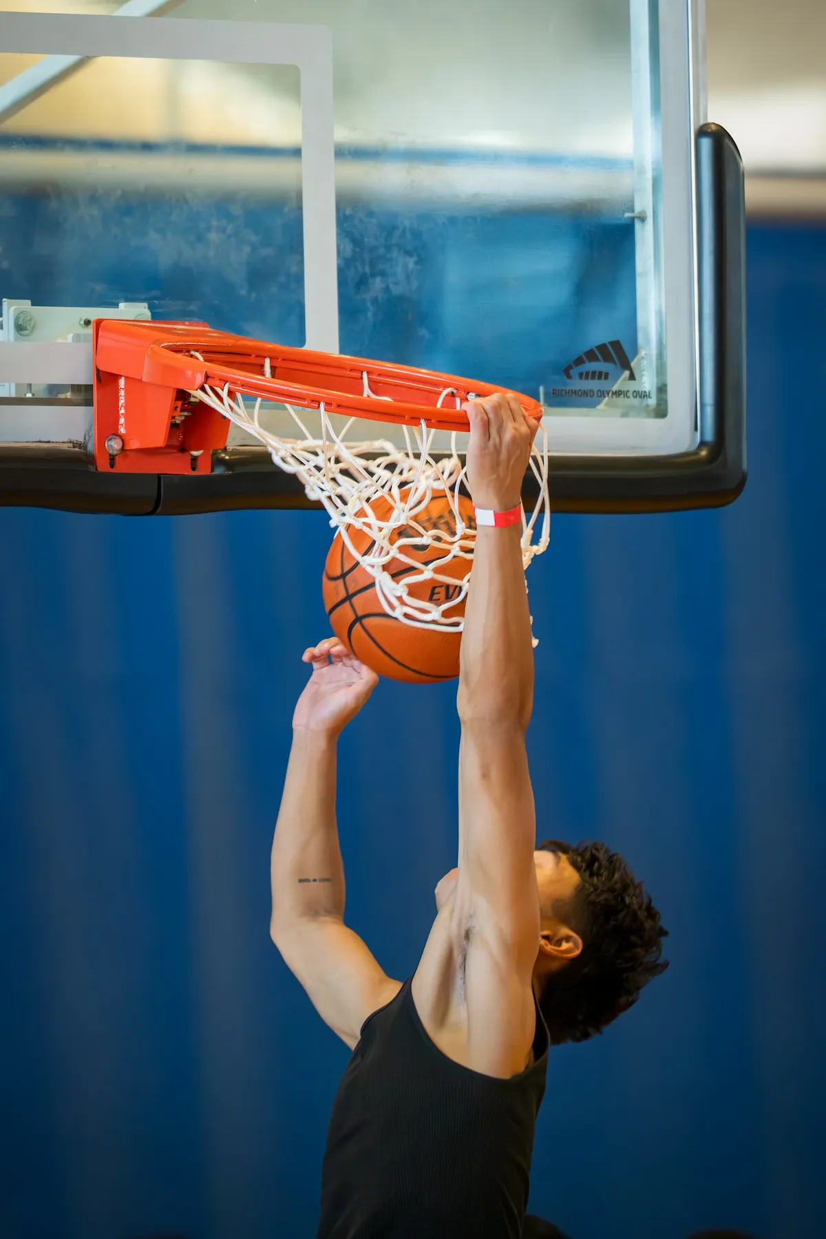 Player dunking and hanging on the rim at 3PB tournament