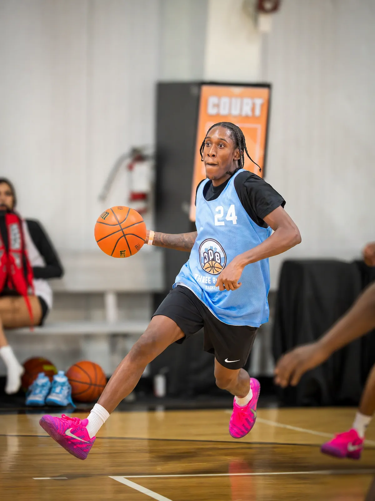 Player completing an acrobatic reverse layup at 3PB tournament
